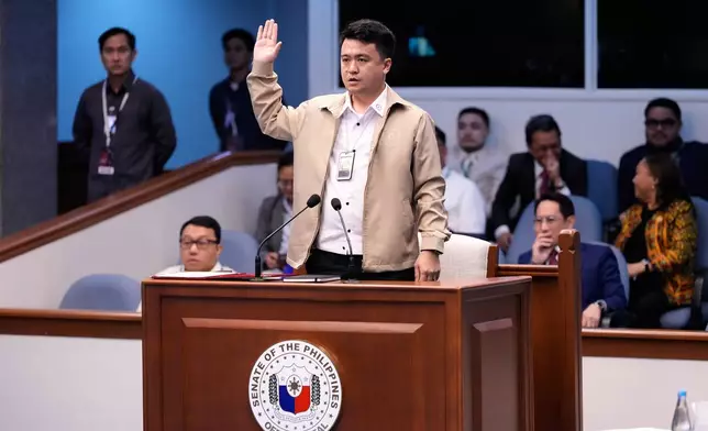 National Bureau of Investigation senior agent John Mark Calilung takes oath as witness during the impeachment trial of Philippine Vice President Sara Duterte at the Philippine Senate in Pasay city, Philippines on Tuesday, July 7, 2026. (AP Photo/Aaron Favila, Pool) ADDITION: Adds this is Pool.