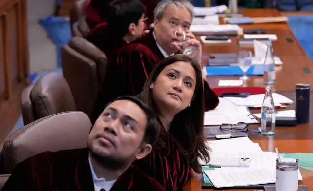 Philippine senator, from left, Mark and his sister Camille Villar and Joel Villanueva look at the projector as documents are shown during the impeachment trial of Philippine Vice President Sara Duterte at the Philippine Senate in Pasay city, Philippines on Tuesday, July 7, 2026. (AP Photo/Aaron Favila, Pool)