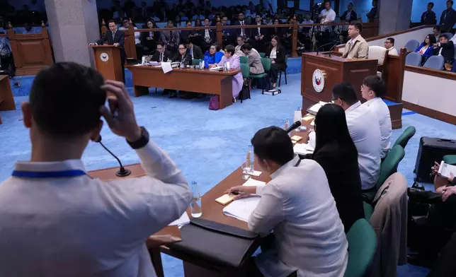National Bureau of Investigation senior agent John Mark Calilung, right, listens as prosecutor and defense teams speak during the impeachment trial of Philippine Vice President Sara Duterte at the Philippine Senate in Pasay city, Philippines on Tuesday, July 7, 2026. (AP Photo/Aaron Favila, Pool)