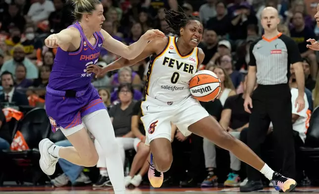 Indiana Fever guard Kelsey Mitchell (0) drives past Phoenix Mercury guard Sami Whitcomb, left, during the first half of a WNBA basketball game, Thursday, July 9, 2026, in Phoenix. (AP Photo/Ross D. Franklin)