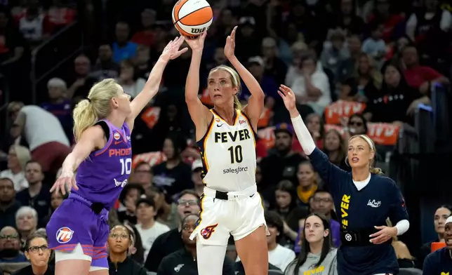 Indiana Fever guard Lexie Hull (10) shoots a 3-pointer over Phoenix Mercury guard Lexi Held (10) as Fever guard Sophie Cunningham, right, looks on during the first half of a WNBA basketball game, Thursday, July 9, 2026, in Phoenix. (AP Photo/Ross D. Franklin)