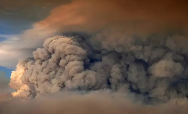 A plumes of smoke from the Camp Fire hang in the air over Moose Lake as multiple wildfires burn in Minnesota's Boundary Waters Canoe Area Wilderness, Tuesday, July 14, 2026. (Anthony Souffle/Minnesota Star Tribune via AP)