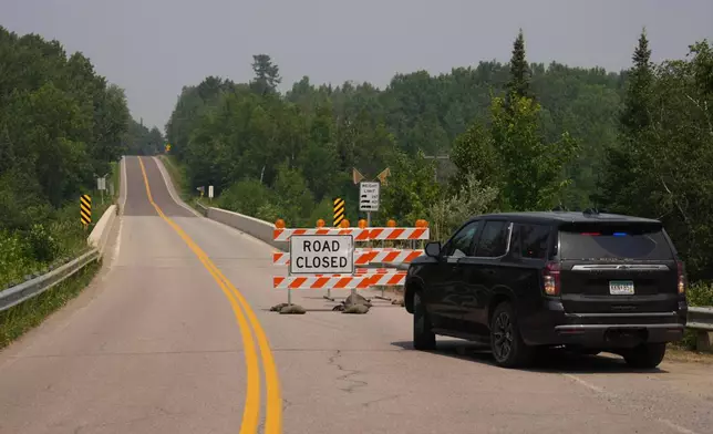 A law enforcement vehicle blocks off a road leading to the Fall Lake entry point, Tuesday, July 14, 2026, near Ely, Minn. (Anthony Soufflé/Minnesota Star Tribune via AP)
