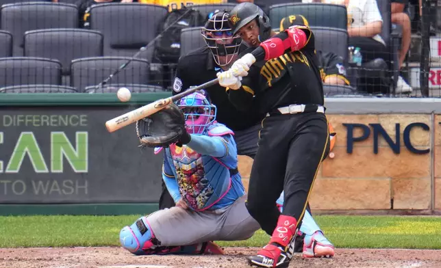Pittsburgh Pirates' Esmerlyn Valdez hits a grand slam home run off Milwaukee Brewers pitcher Aaron Ashby during the seventh inning of the first game of a baseball double header in Pittsburgh, Saturday, July 11, 2026. (AP Photo/Gene J. Puskar)