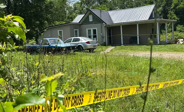 The dilapidated home where authorities say they removed 16 children and arrested four adults remains blocked off by crime scene tape on Wednesday, July 1, 2026 in Hamden, Ohio. (AP Photo/Julie Carr Smyth)
