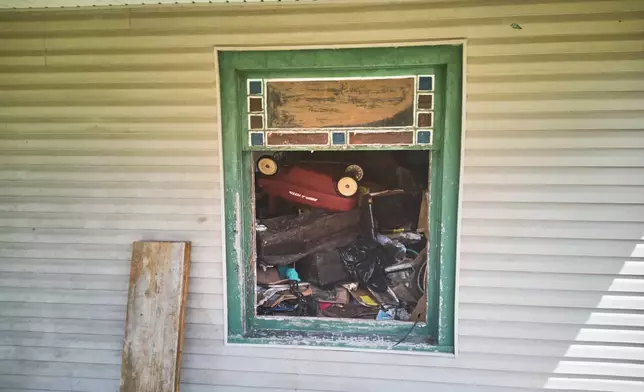 Debris is seen inside a home where authorities say they removed 16 children and arrested four adults in Hamden, Ohio, Wednesday, July 1, 2026. (AP Photo/Carolyn Kaster)