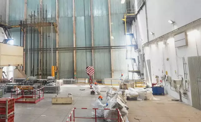 Workers package reactor components on the reactor operating floor of the former nuclear power plant of Latina, Italy, Thursday, June 18, 2026. (AP Photo/Alessandra Tarantino)