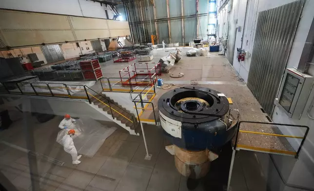 Workers package reactor components on the reactor operating floor of the former nuclear power plant of Latina, Italy, Thursday, June 18, 2026. (AP Photo/Alessandra Tarantino)