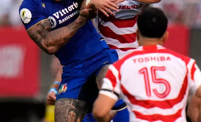 Italy's Monty Ioane, left, jumps for the ball during the Nations Championship rugby match between Japan and Italy in Tokyo, Saturday, July 4, 2026. (AP Photo/Shuji Kajiyama)