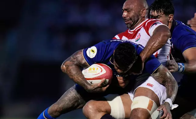 Italy's Monty Ioane, left, is tackled by Japan's Michael Leitch during the Nations Championship rugby match between Japan and Italy in Tokyo, Saturday, July 4, 2026. (AP Photo/Shuji Kajiyama)