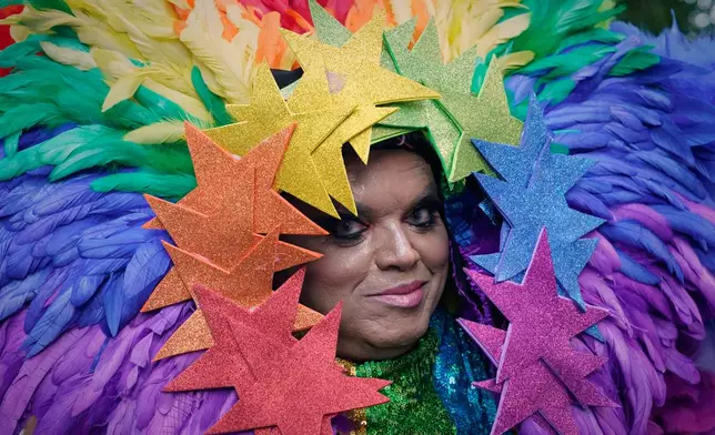 A reveler takes part in the annual Pride parade in Madrid, Spain, Saturday, July 4, 2026. (AP Photo/Andrea Comas)