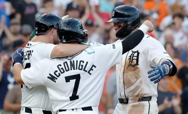 Detroit Tigers' Spencer Torkelson, right, celebrates with Jake Rogers, left, and Kevin McGonigle (7) after hitting a three-run home run against the Athletics during the fifth inning of a baseball game Wednesday, July 8, 2026, in Detroit. (AP Photo/Duane Burleson)