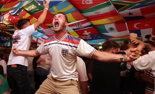England soccer fans celebrate during the World Cup semifinal soccer match between England and Argentina at The Clock pub in Hebburn, England, Wednesday, July 15, 2026. (AP Photo/Scott Heppell)