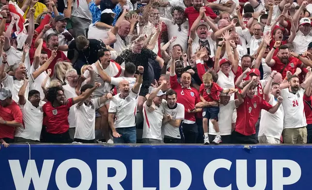 England fans react after England's Anthony Gordon scored the opening goal during the World Cup semifinal soccer match between England and Argentina in Atlanta, Wednesday, July 15, 2026. (AP Photo/Rebecca Blackwell)