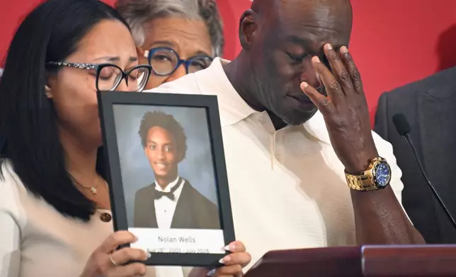 Elmore Wonsley, right, pauses from speaking as wife Christine Wonsley holds a photo of her deceased son, Nolan Wells, as they appear at the National Urban League's annual conference, Thursday, July 30, 2026, in Nashville, Tenn. (AP Photo/John Amis)
