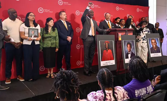 Attorney Ben Crump shouts from the podium as he joins Christine Wonsley and Elmore Wonsley, left, mother and step father of Nolan Wells appear at the National Urban League's annual conference, to share updates on the deaths of their son as well as Daniel Erving, and Tyler Smith, Thursday, July 30, 2026, in Nashville, Tenn. (AP Photo/John Amis)