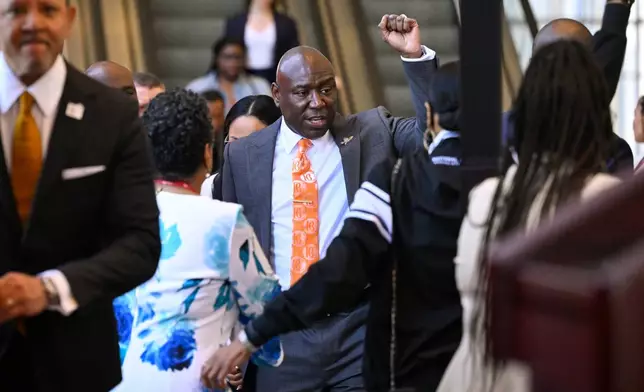 Attorney Ben Crump raises his fist as he arrives with clients Christine Wonsley and Elmore Wonsley, mother and step father of Nolan Wells who was found dead after taking a July 4 boat trip with friends, as they appear at the National Urban League's annual conference, Thursday, July 30, 2026, in Nashville, Tenn. (AP Photo/John Amis)