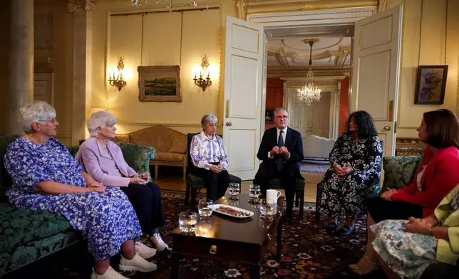 Britain's Prime Minister Keir Starmer, center, attends a meeting with campaigners to discuss historical forced adoption, at Downing Street, in London, Thursday July 2, 2026. (Isabel Infantes/Pool Photo via AP)
