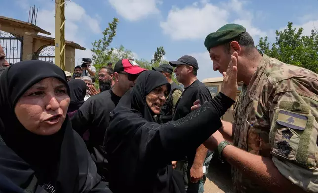 Lebanese army soldiers prevent residents from entering the southern village of Zawtar al-Gharbiyeh while deploying at the village entrance, Lebanon, Wednesday, July 22, 2026. (AP Photo/Mohammed Zaatari)