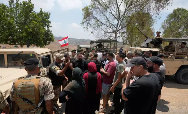 Lebanese army soldiers prevent residents from entering the southern village of Zawtar Al Gharbieh while deploying at the village entrance, Lebanon, Wednesday, July 22, 2026. (AP Photo/Mohammed Zaatari)
