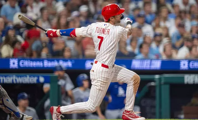 Philadelphia Phillies' Trea Turner hits a three-run home run during the sixth inning of a baseball game against the Los Angeles Dodgers, Monday, July 20, 2026, in Philadelphia. (AP Photo/Chris Szagola)