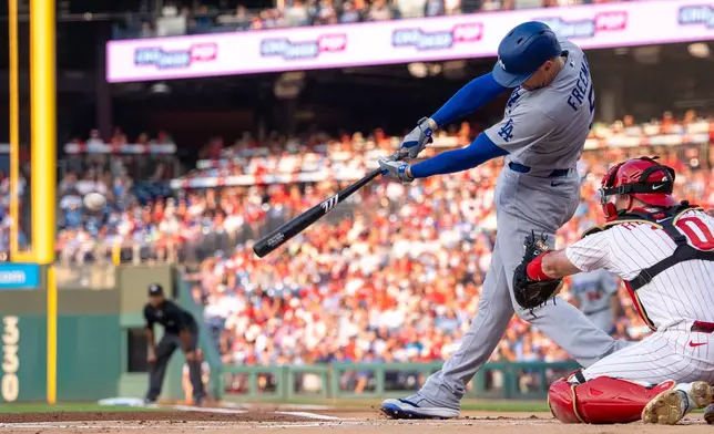 Los Angeles Dodgers' Freddie Freeman hits a single during the first inning of a baseball game against the Philadelphia Phillies, Monday, July 20, 2026, in Philadelphia. (AP Photo/Chris Szagola)
