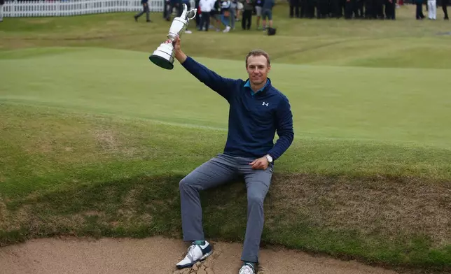 FILE - Jordan Spieth of the United States holds the trophy after winning the British Open Golf Championships at Royal Birkdale, Southport, England, July 23, 2017. (AP Photo/Dave Thompson, File)
