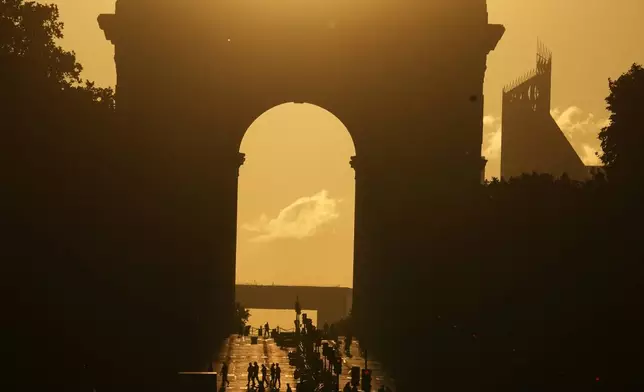 The sun sets behind the Arc de Triomphe after the last stage of the Tour de France cycling race with start and finish in Paris, Sunday, July 26, 2026. (AP Photo/Thibault Camus)