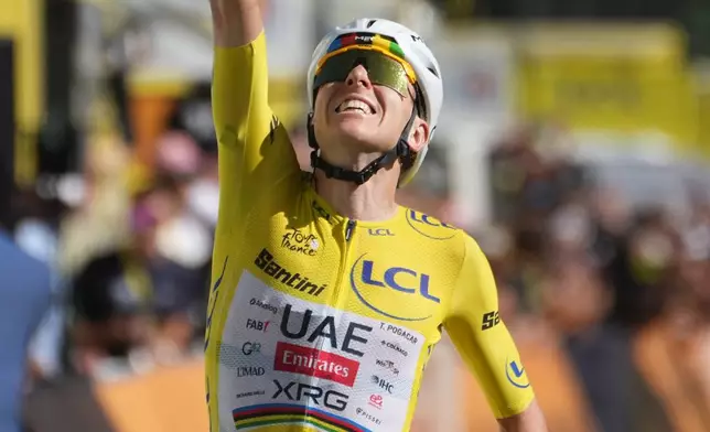 Slovenia's Tadej Pogacar, wearing the overall leader's yellow jersey, crosses the finish line to win the nineteenth stage of the Tour de France cycling race with start in Gap and finish in Alpe d'Huez, France, Friday, July 24, 2026. (AP Photo/Thibault Camus)