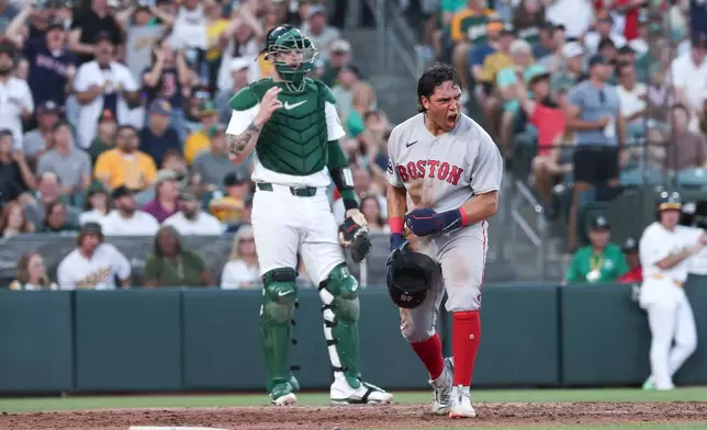 Boston Red Sox's Anthony Seigler, right, celebrates after scoring during the fifth inning of a baseball game against the Athletics Thursday, July 30, 2026, in West Sacramento, Calif. (AP Photo/Sara Nevis)