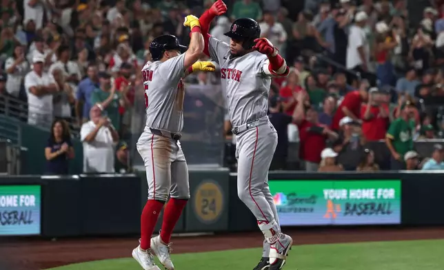 Boston Red Sox's Willson Contreras, right, celebrates with Caleb Durbin after hitting a home run during the eighth inning of a baseball game against the Athletics Thursday, July 30, 2026, in West Sacramento, Calif. (AP Photo/Sara Nevis)