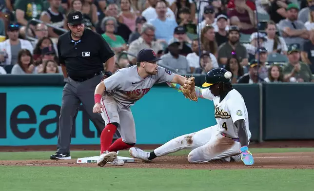 Boston Red Sox third baseman Caleb Durbin, left, attempts to get Athletics' Lawrence Butler (4) out during the sixth inning of a baseball game Thursday, July 30, 2026, in West Sacramento, Calif. (AP Photo/Sara Nevis)
