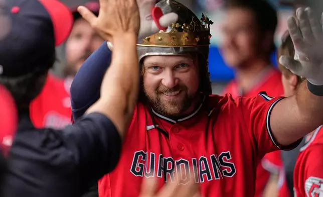 Cleveland Guardians' Rhys Hoskins celebrates in the dugout after hitting a home run in the first inning of a baseball game against the Minnesota Twins in Cleveland, Monday, July 20, 2026. (AP Photo/Sue Ogrocki)