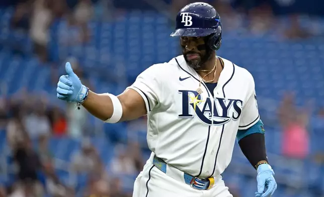 Tampa Bay Rays' Yandy Díaz celebrates as he rounds the bases after home run during the first inning of a baseball game against the Texas Rangers Wednesday, July 29, 2026, in St. Petersburg, Fla. (AP Photo/Jason Behnken)