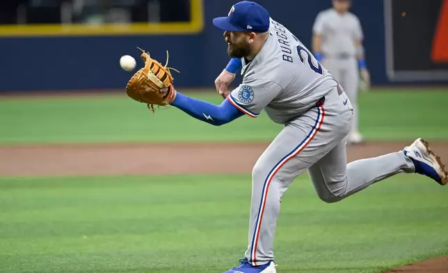 Texas Rangers first baseman Jake Burger catches a pop up hit by Tampa Bay Rays' Nick Fortes, not pictured, during the second inning of a baseball game Wednesday, July 29, 2026, in St. Petersburg, Fla. (AP Photo/Jason Behnken)