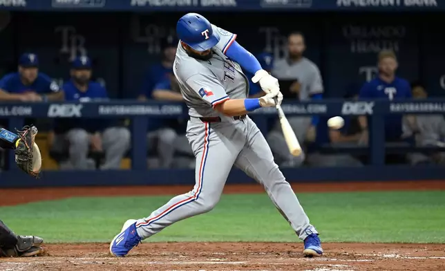 Texas Rangers' Jake Burger doubles during the seventh inning of a baseball game against the Tampa Bay Rays Wednesday, July 29, 2026, in St. Petersburg, Fla. (AP Photo/Jason Behnken)