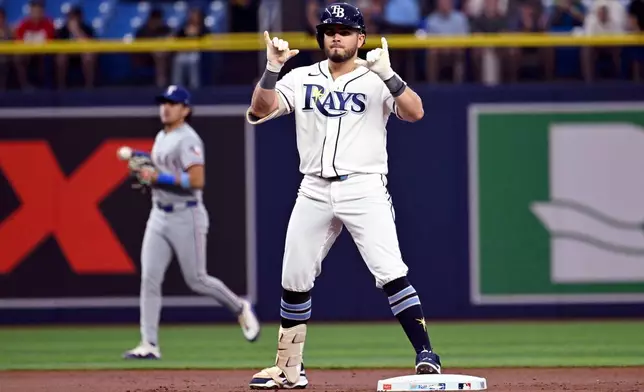 Tampa Bay Rays' Jonathan Aranda celebrates after his double during the third inning of a baseball game against the Texas Rangers Wednesday, July 29, 2026, in St. Petersburg, Fla. (AP Photo/Jason Behnken)