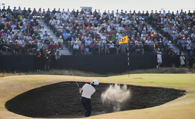 Tommy Fleetwood of England plays out of a bunker on the 14th green during the third day of the British Open Golf championships at Royal Birkdale golf club, in Southport, England, Saturday, July 18, 2026. (AP Photo/Jon Super)