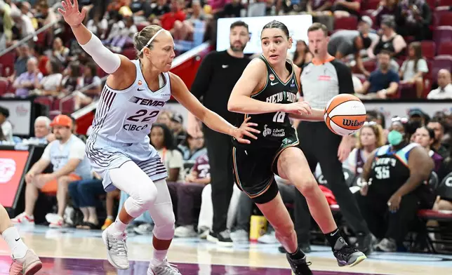Toronto Tempo's Julie Allemand (22) defends against New York Liberty's Pauline Astier (18) during the second half of a WNBA basketball game in Montreal, on Sunday, July 12, 2026. (Graham Hughes/The Canadian Press via AP)