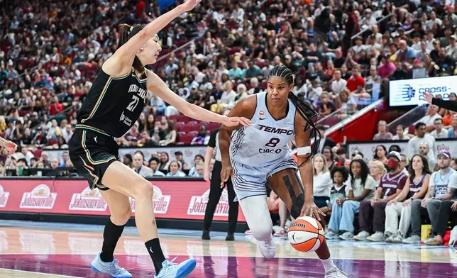 Toronto Tempo's Nyara Sabally (8) is guarded by New York Liberty's Han Xu, left, as she drives to the net during the first half of a WNBA basketball game in Montreal, Sunday, July 12, 2026. (Graham Hughes/The Canadian Press via AP)