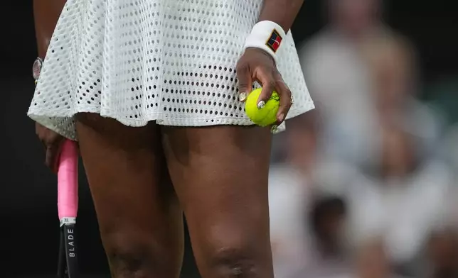 Serena Williams of the United States holds a ball as she prepares to serve against Maya Joint of Australia in their first round women's singles match at the Wimbledon Tennis Championships in London, Tuesday, June 30, 2026. (AP Photo/Maja Smiejkowska)