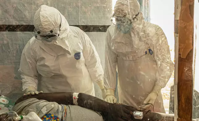 FILE - Health workers attend to an Ebola patient at the Rwampara treatment Center in Ituri, Congo, Thursday, June 18, 2026. (AP Photo/Moses Sawasawa, file)