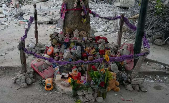 Stuffed animals and toys found at the OPP 25 residential building, which collapsed during the earthquake, are piled into a makeshift memorial in La Guaira, Venezuela, Friday, July 17, 2026. (AP Photo/Ariana Cubillos)