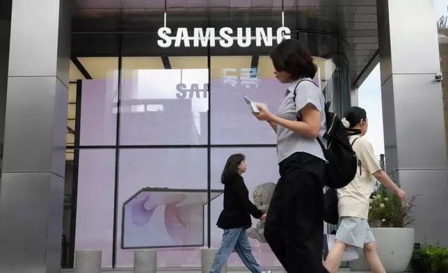 People pass by Samsung Gangnam store in Seoul, South Korea, Thursday, July 30, 2026. (AP Photo/Ahn Young-joon)