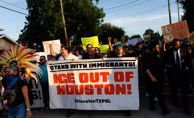 People march through the streets during a vigil for Lorenzo Salgado Araujo, a Mexican national fatally shot by a federal immigration agent a day prior, Wednesday, July 8, 2026, in Houston. (AP Photo/Mark Felix)