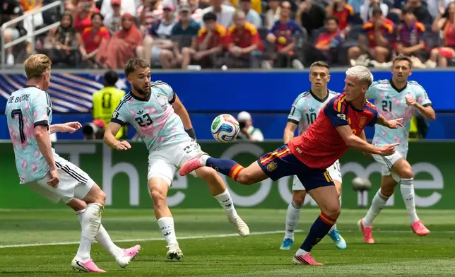 Spain's Dani Olmo (10), right, and Belgium's Nicolas Raskin (23) challenge for the ball during the World Cup quarterfinal soccer match between Spain and Belgium in Inglewood, Calif., near Los Angeles, Friday, July 10, 2026. (AP Photo/Andre Penner)