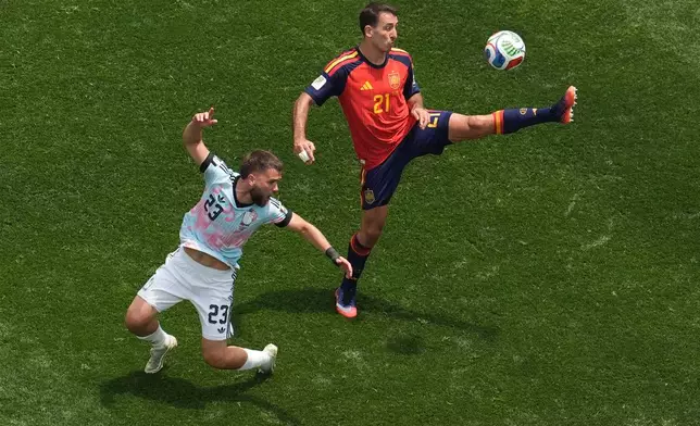 Spain's Mikel Oyarzabal (21) reaches for the ball behind Belgium's Nicolas Raskin (23) during the World Cup quarterfinal soccer match between Spain and Belgium in Inglewood, Calif., near Los Angeles, Friday, July 10, 2026. (AP Photo/Marcio J. Sanchez)
