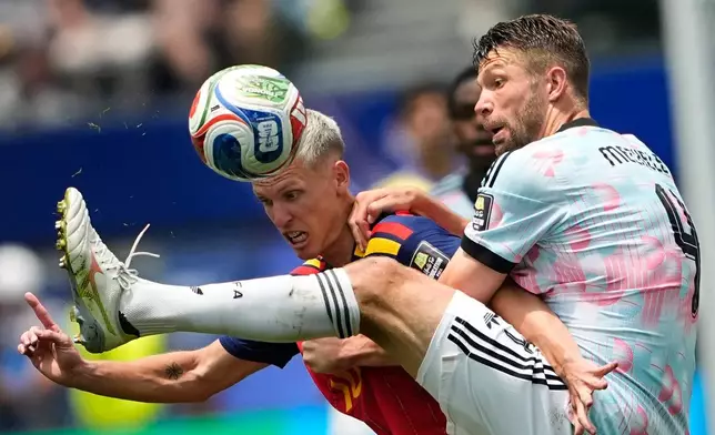 Spain's Dani Olmo (10) battles for the ball with Belgium's Brandon Mechele (4) during the World Cup quarterfinal soccer match between Spain and Belgium in Inglewood, Calif., near Los Angeles, Friday, July 10, 2026. (AP Photo/Lindsey Wasson)