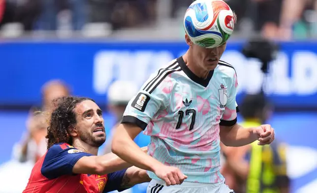 Belgium's Charles De Ketelaere heads the ball flanked by Spain's Marc Cucurella during the World Cup quarterfinal soccer match between Spain and Belgium in Inglewood, Calif., near Los Angeles, Friday, July 10, 2026. (AP Photo/Jae C. Hong)