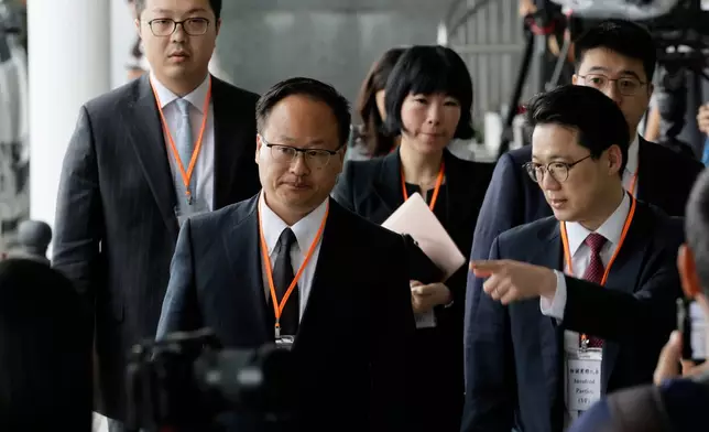Jenkin Suen, counsel for the Hong Kong government leaves for a lunch break following the closing submissions at the hearing of an independent committee investigating last year's Tai Po fire, in Hong Kong, Friday, July 17, 2026. (AP Photo/May James)